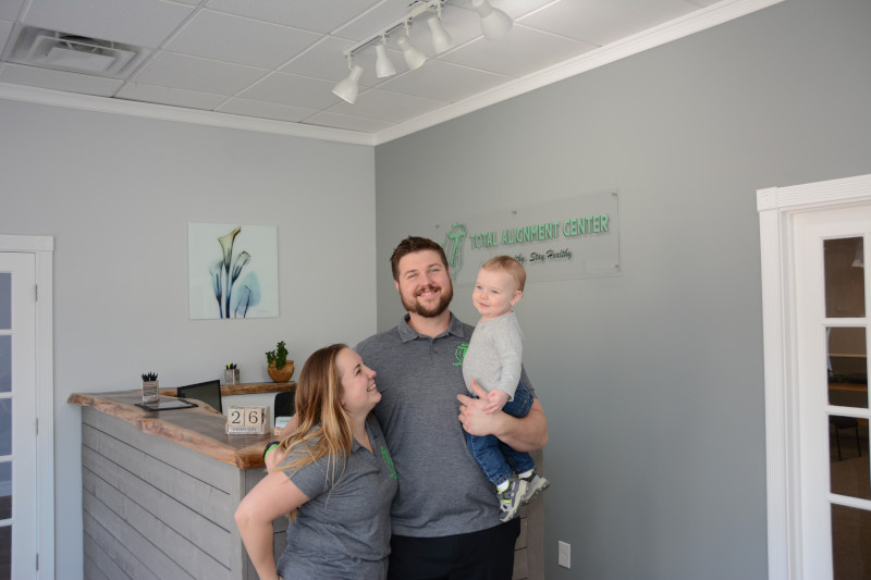 Total Alignment Center Family Welcome – Chiropractor Manahawkin NJ A cheerful family poses inside the Total Alignment Center office, reflecting a warm and family-friendly chiropractic environment – Chiropractor Manahawkin NJ.