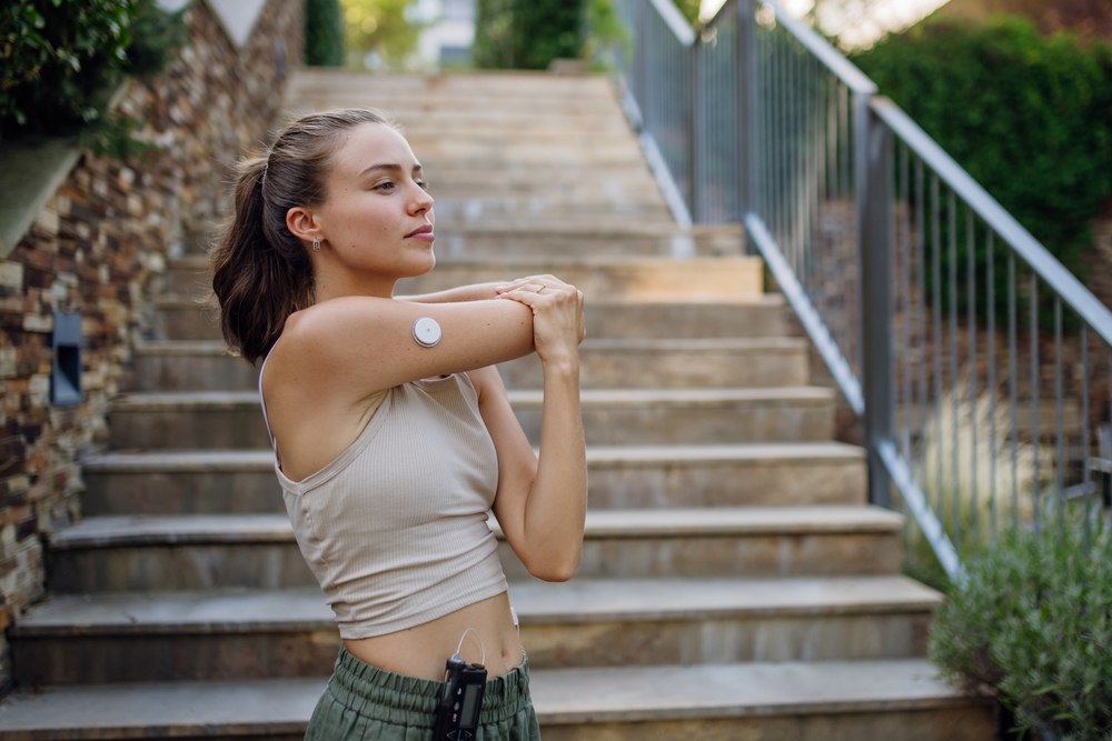 Woman performing a shoulder stretch outdoors, focusing on flexibility, posture improvement, and rehabilitation – Physical Therapy in Manahawkin, NJ.